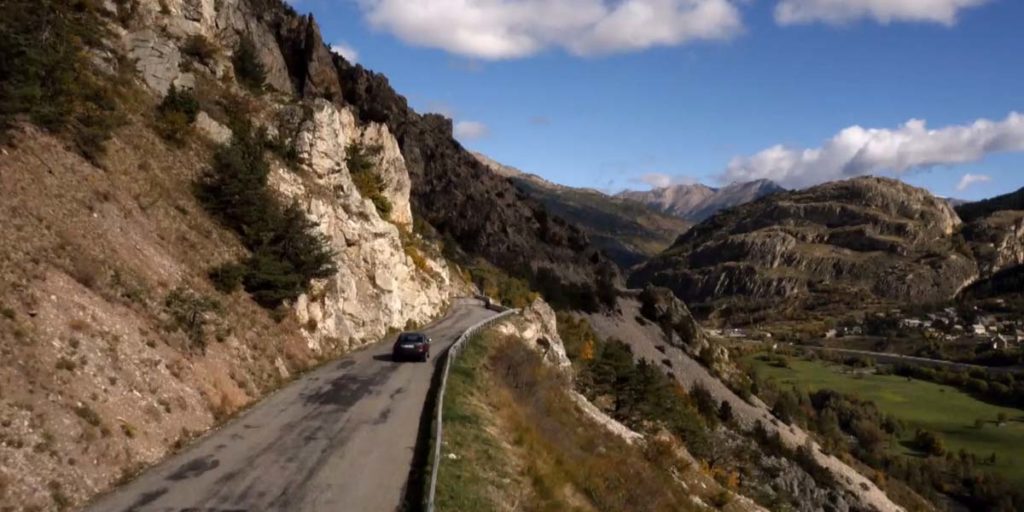 une voiture sur les routes montagneuses de la vallée de la Clarée pour la série Alex Hugo